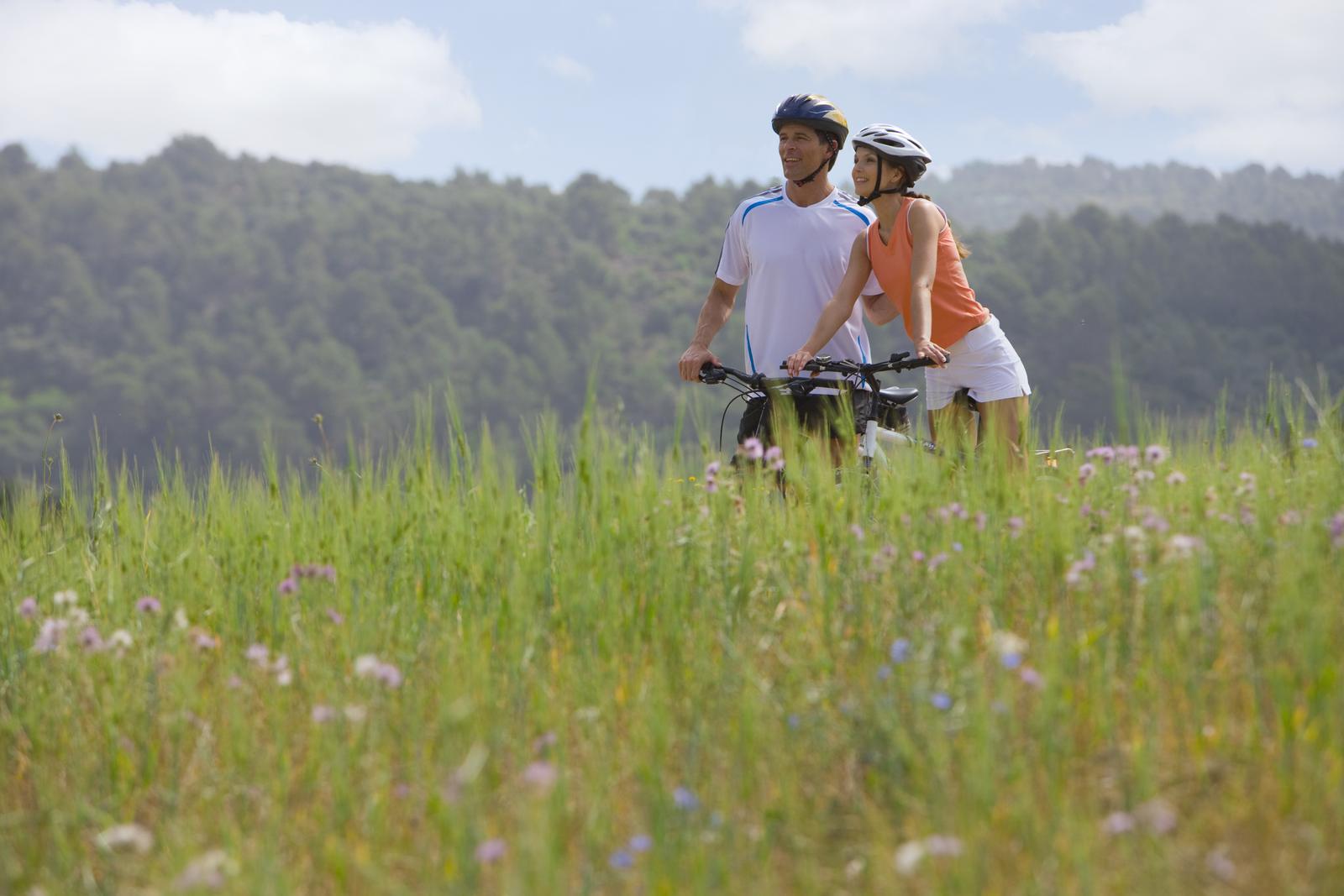 Two cyclists in green countryside