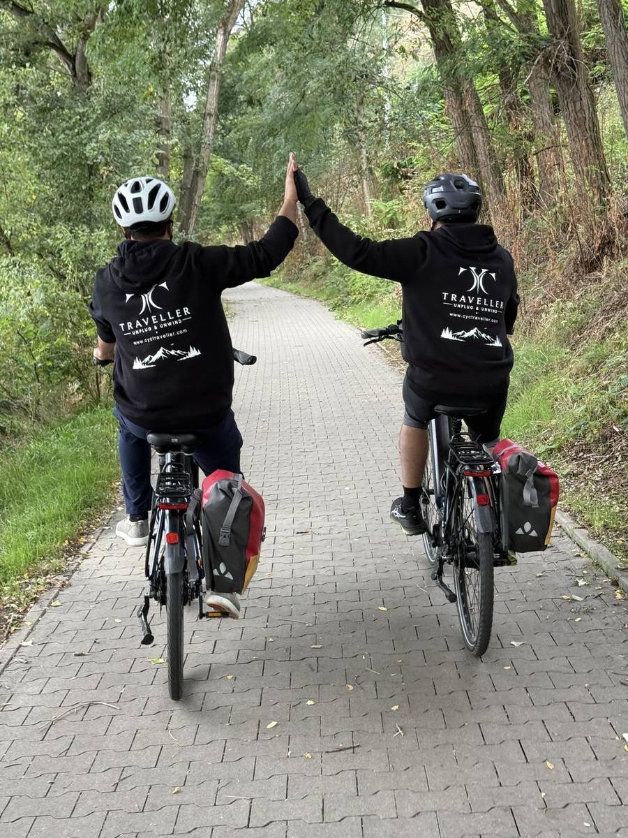 Two CYC Traveller riders high-fiving on the Elbe cycle path